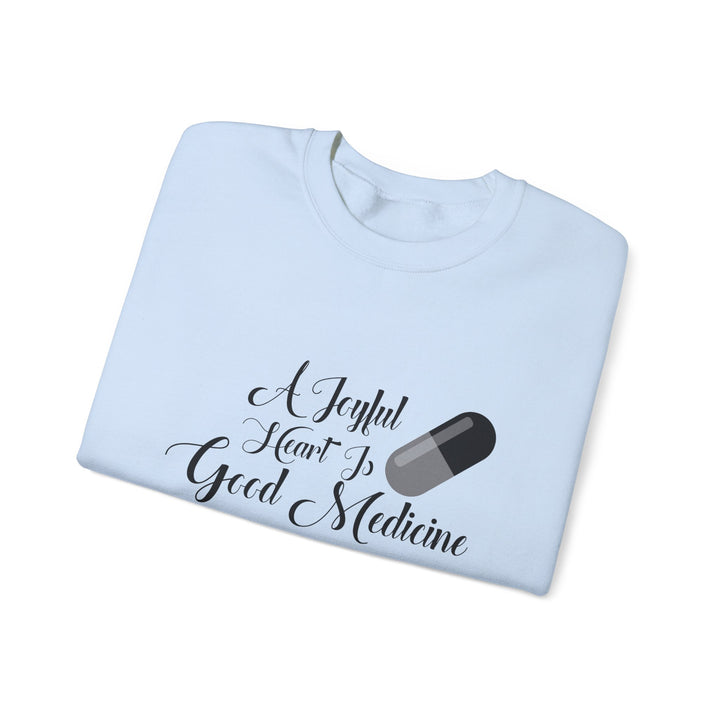 A Joyful Heart Is Good Medicine Unisex Heavy Blend™ Crewneck Sweatshirt