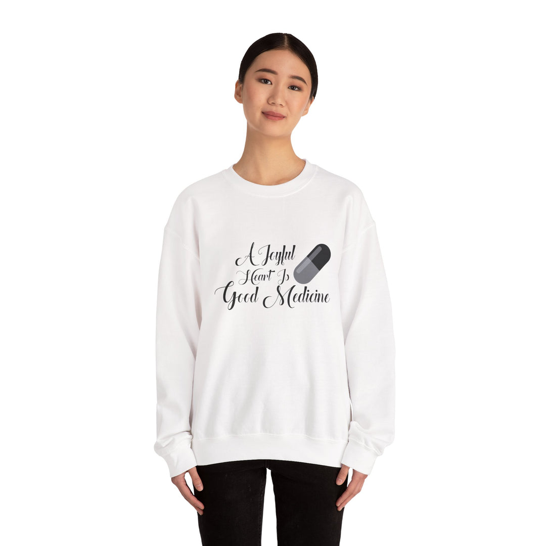 A Joyful Heart Is Good Medicine Unisex Heavy Blend™ Crewneck Sweatshirt