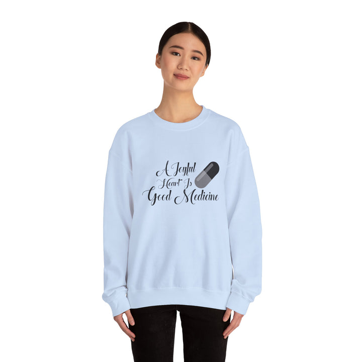 A Joyful Heart Is Good Medicine Unisex Heavy Blend™ Crewneck Sweatshirt
