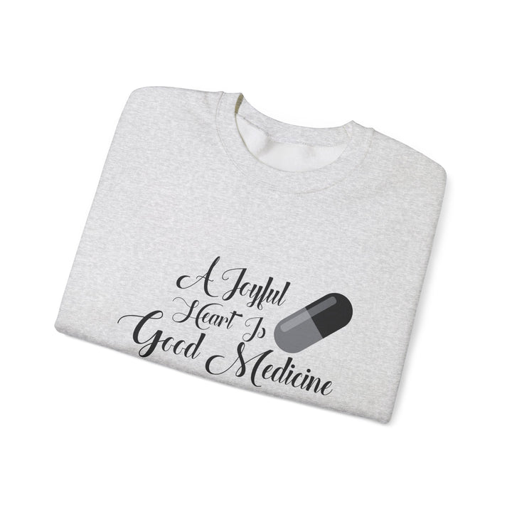 A Joyful Heart Is Good Medicine Unisex Heavy Blend™ Crewneck Sweatshirt