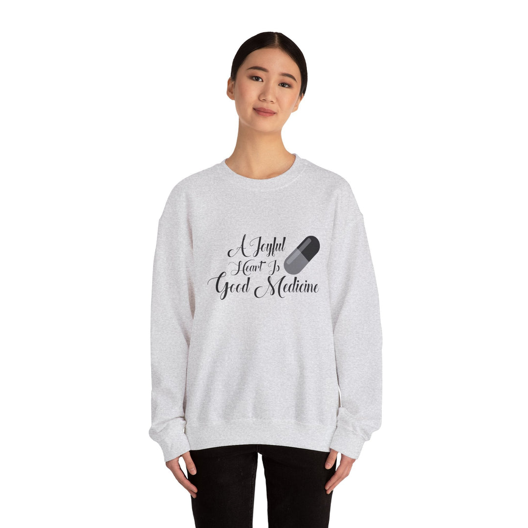 A Joyful Heart Is Good Medicine Unisex Heavy Blend™ Crewneck Sweatshirt - Faith Scripture Gift | Gifts Of Words