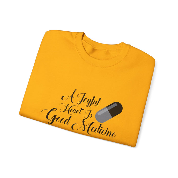 A Joyful Heart Is Good Medicine Unisex Heavy Blend™ Crewneck Sweatshirt - Faith Scripture Gift | Gifts Of Words