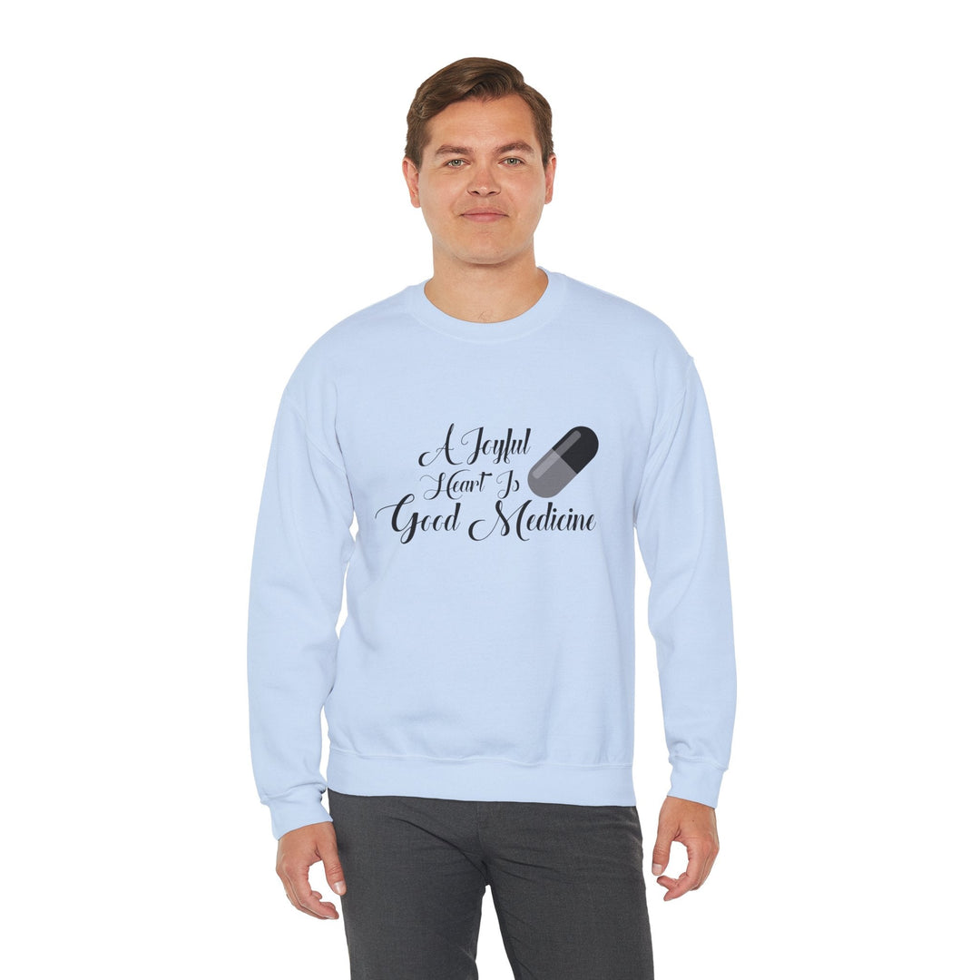 A Joyful Heart Is Good Medicine Unisex Heavy Blend™ Crewneck Sweatshirt - Faith Scripture Gift | Gifts Of Words