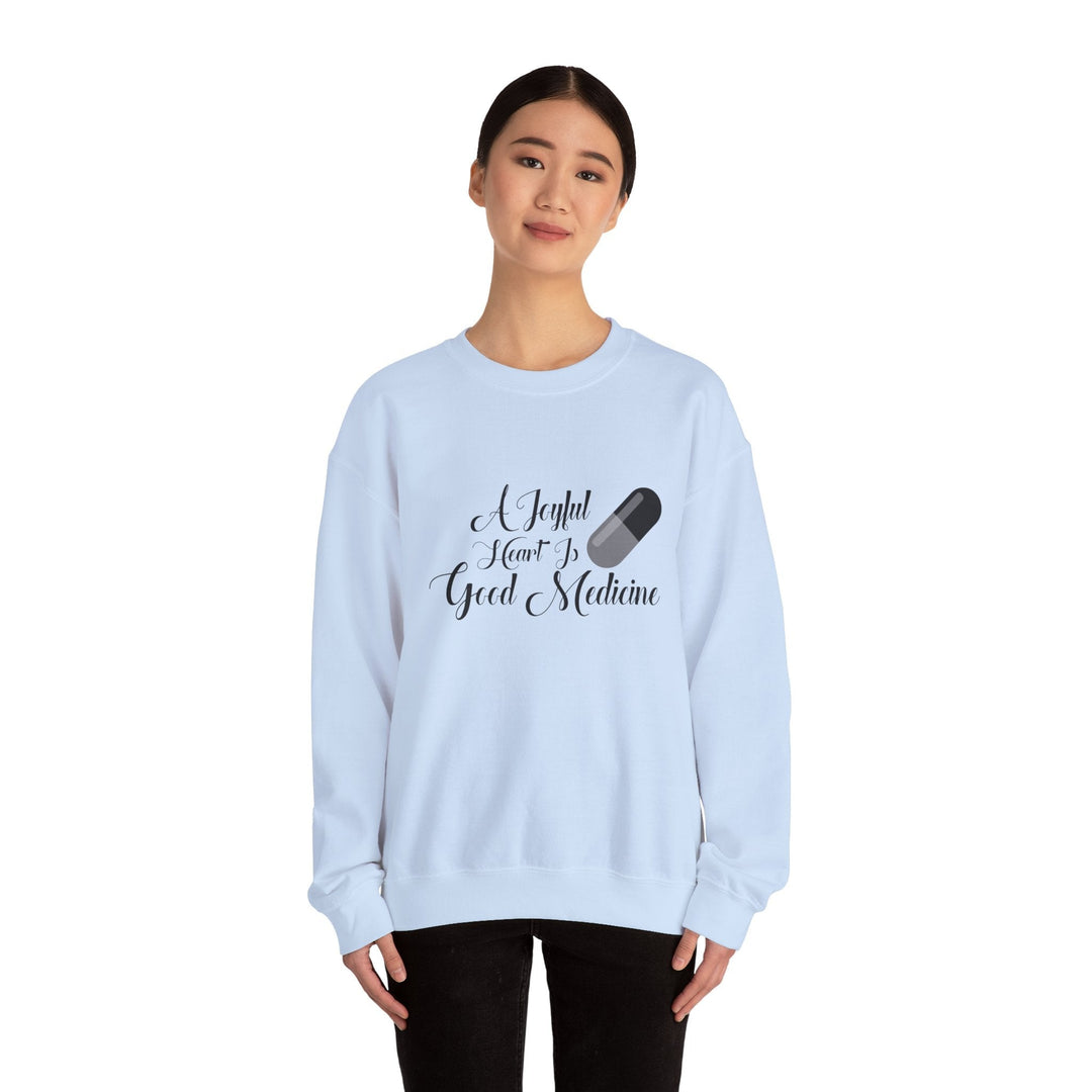 A Joyful Heart Is Good Medicine Unisex Heavy Blend™ Crewneck Sweatshirt - Faith Scripture Gift | Gifts Of Words