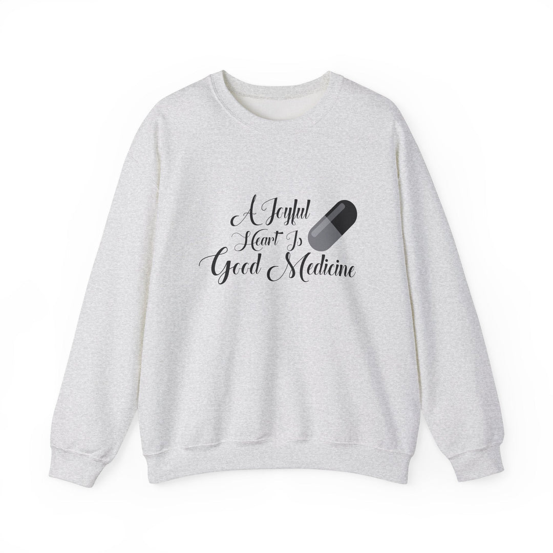 A Joyful Heart Is Good Medicine Unisex Heavy Blend™ Crewneck Sweatshirt - Faith Scripture Gift | Gifts Of Words