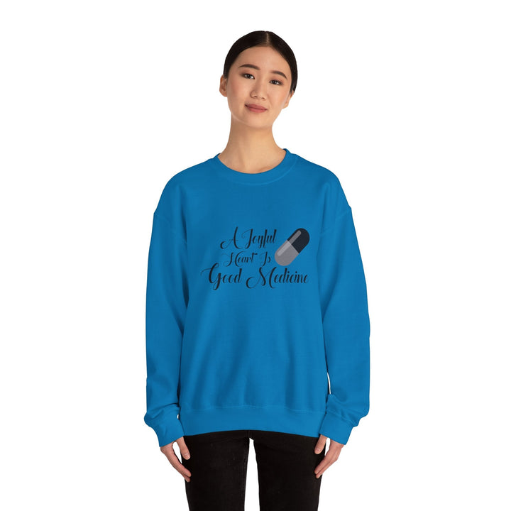 A Joyful Heart Is Good Medicine Unisex Heavy Blend™ Crewneck Sweatshirt - Faith Scripture Gift | Gifts Of Words