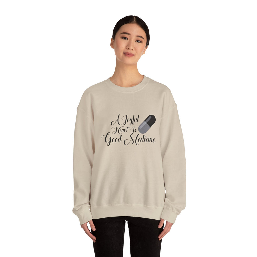 A Joyful Heart Is Good Medicine Unisex Heavy Blend™ Crewneck Sweatshirt - Faith Scripture Gift | Gifts Of Words