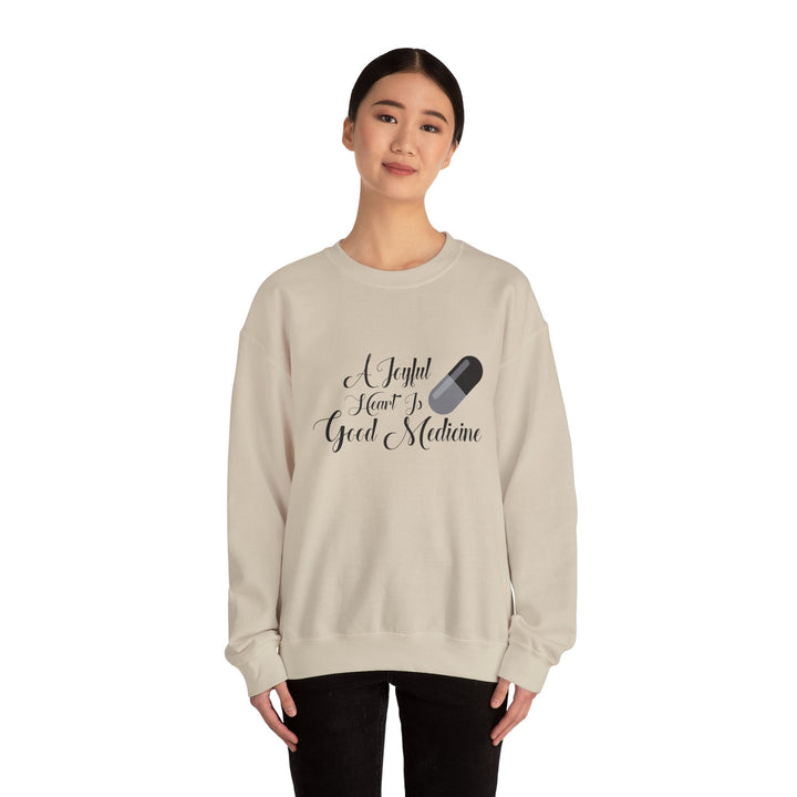 A Joyful Heart Is Good Medicine Unisex Heavy Blend™ Crewneck Sweatshirt - Faith Scripture Gift | Gifts Of Words