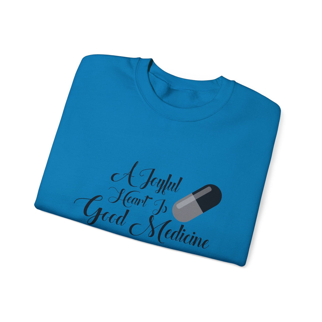 A Joyful Heart Is Good Medicine Unisex Heavy Blend™ Crewneck Sweatshirt - Faith Scripture Gift | Gifts Of Words