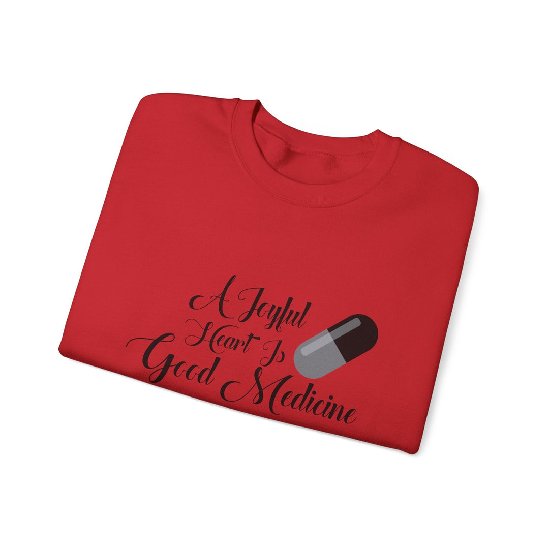 A Joyful Heart Is Good Medicine Unisex Heavy Blend™ Crewneck Sweatshirt - Faith Scripture Gift | Gifts Of Words