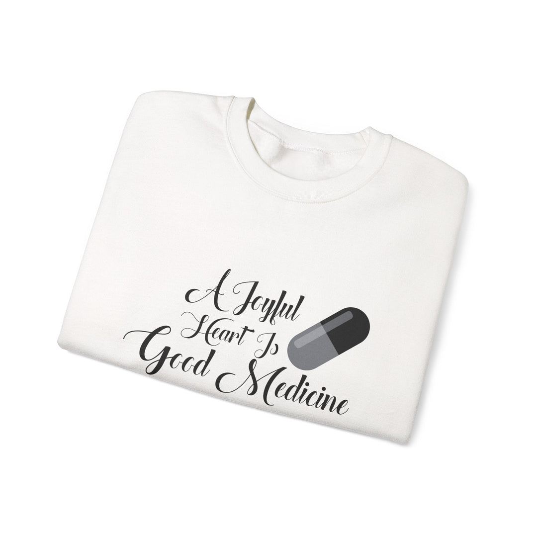 A Joyful Heart Is Good Medicine Unisex Heavy Blend™ Crewneck Sweatshirt - Faith Scripture Gift | Gifts Of Words